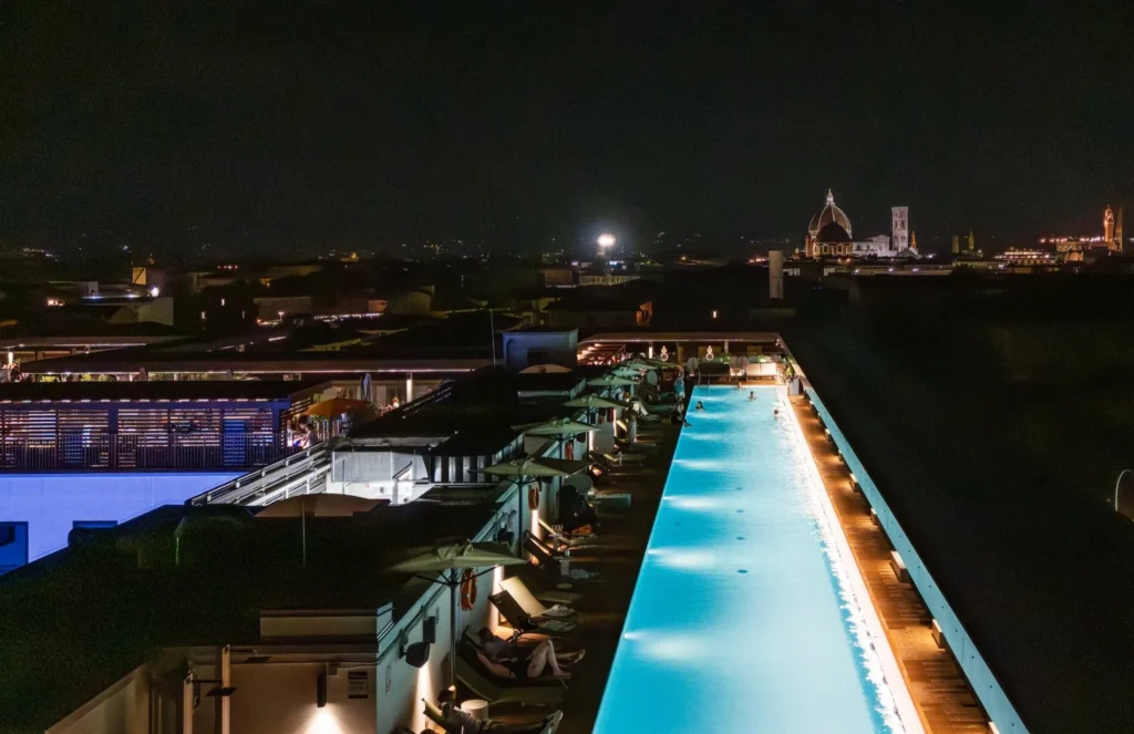 Illuminated rooftop pool at night